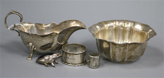 A silver cream jug, silver bowl, silver napkin ring, modern silver frog pin cushion and a white metal coin holder.